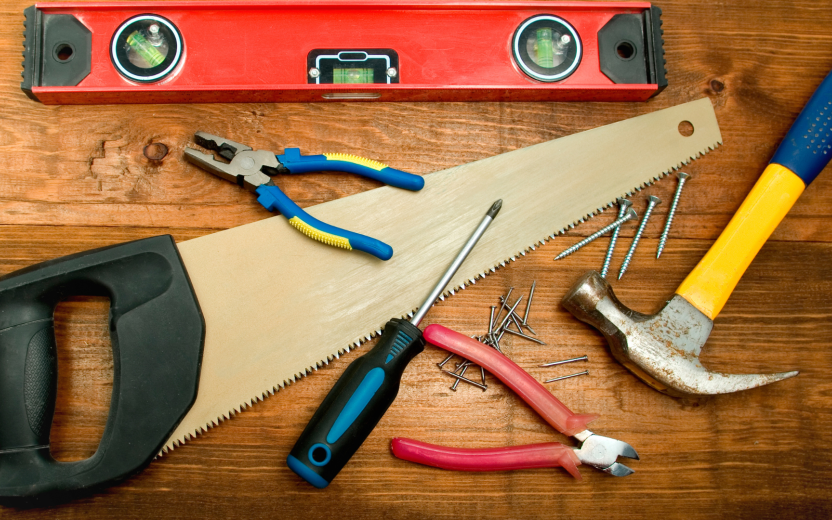 assorted tools on wooden surface